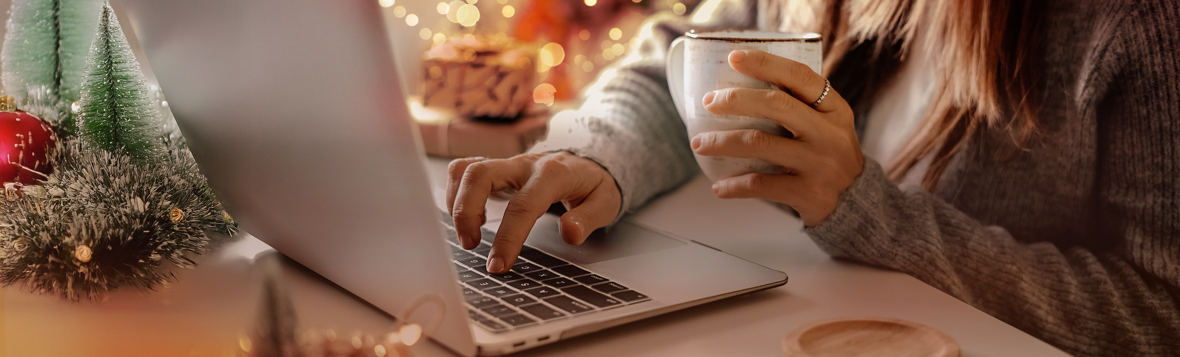 adult standing in the snow, holding an umbrella.