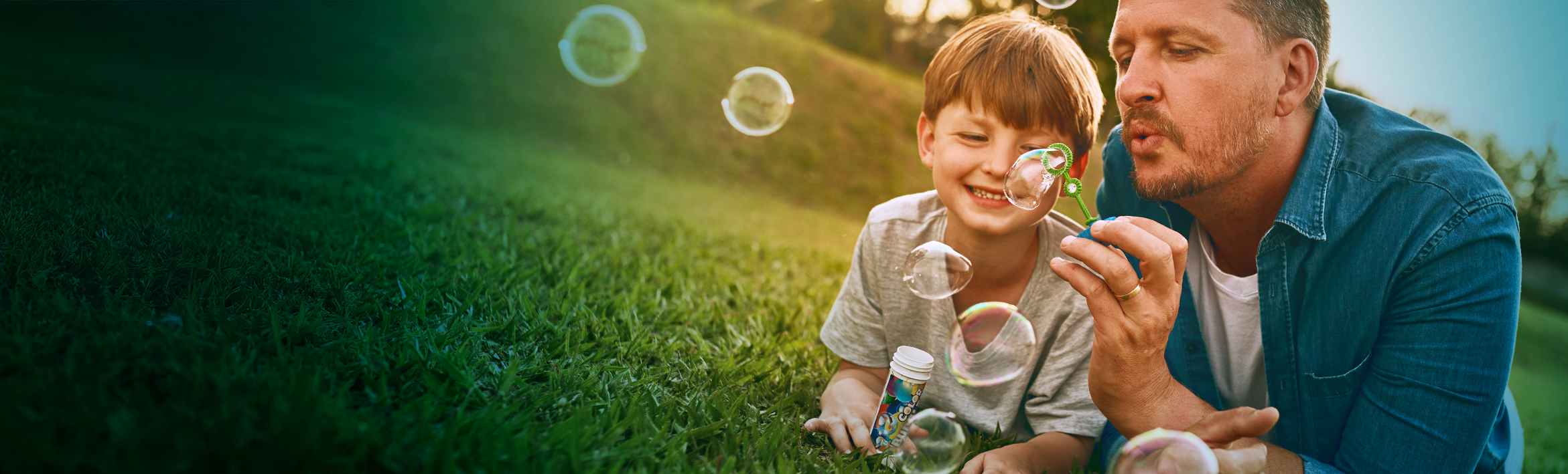 Toddler holding a teddy bear and smiling